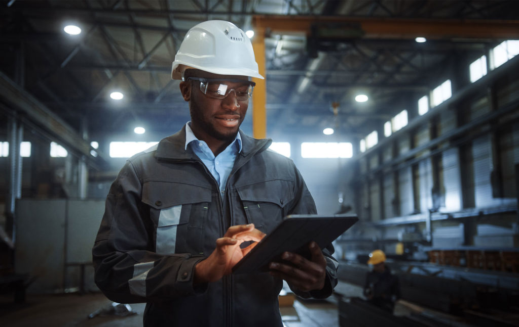 Person utilizing a tablet for construction monitoring activities.