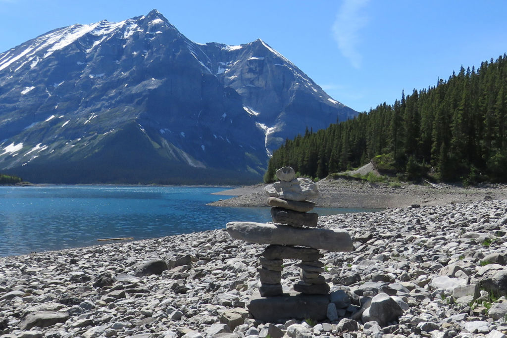 Inukshuk in front of a mountain landscape